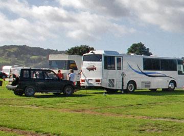 Large motorhome towing a small utility car