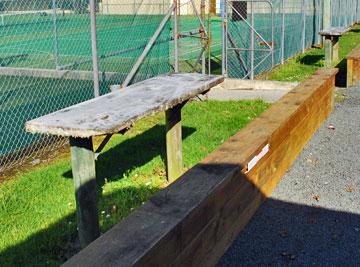 Outdoor seating and tables beside the tennis court