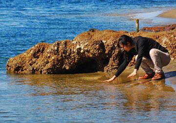 Checking the crystal clear water at the beach