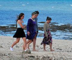 Teenagers walking along the beach