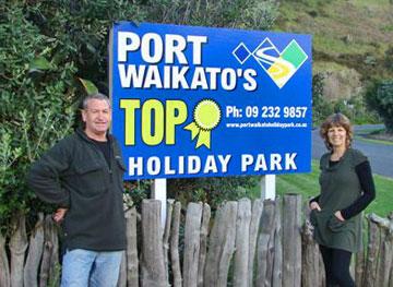 Pat and Deidre at the entrance to their holiday park