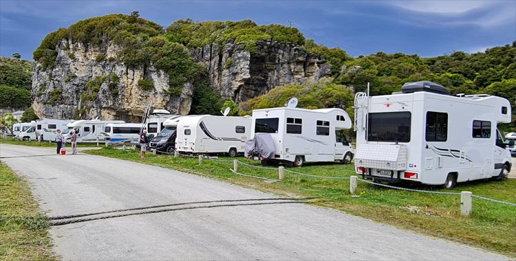 Parking area with a rugged cliff face backdrop