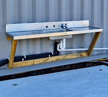 Fish cleaning sink behind the facilities building