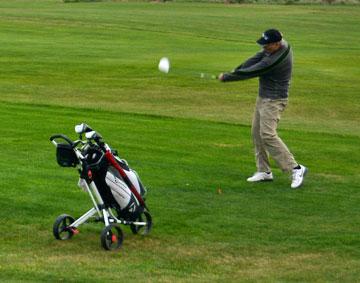 Playing golf in the late afternoon.