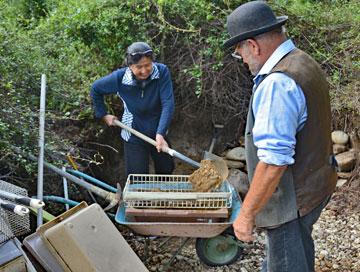 Shuping getting taught how to use a shovel