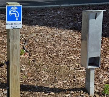 Drinking water tap with a donation box