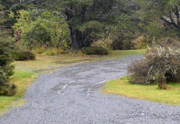 Narrow metal road down to the campsite