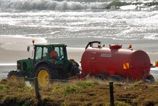 Water tank being driven up and down the beach