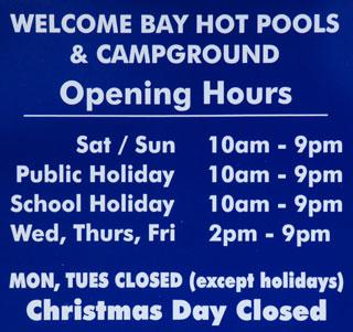 Welcome Bay Hot Water Pools and Campground opening hours sign