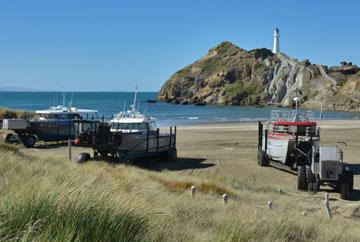 Commercial fishing boats returning back to the beach