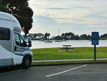 Beachfront parking between the signs