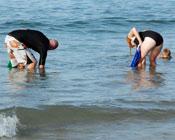 Couple gathering Tua Tua shellfish